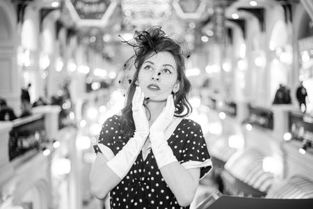 Moscow, 2019, GUM, Red Square. Photo shoot in retro style. A girl in a retro polka dot dress, white...