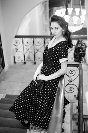 Moscow, 2019, GUM, Red Square. Photo shoot in retro style. A girl in a retro polka dot dress, white gloves and a veil on Moscow's red Square. Photo shoot in the style of the 80s and 90s.のeditorial素材