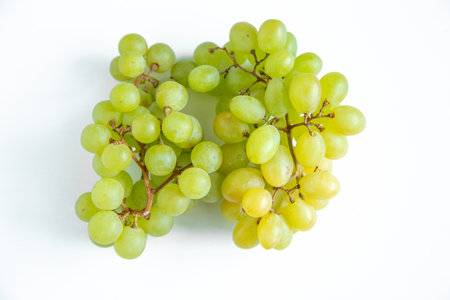 bunch of green grapes isolated on white background. top view.