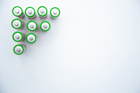 The batteries are arranged in a triangle in the upper corner of the photo on a white background. top view, flat lay, copy space, isolateの写真素材