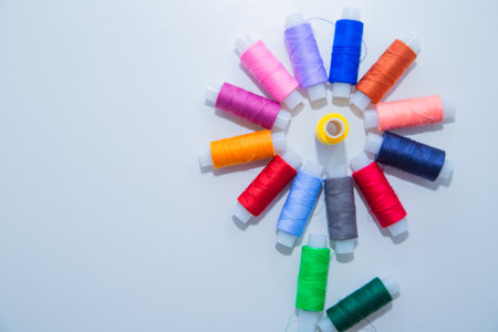Skeins with threads are in the form of a creative flower on a white background. top view, flat lay,...
