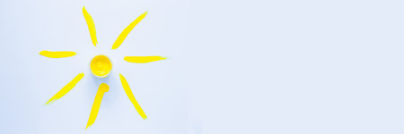 A jar with a yellow red one stands in the center like the sun, rays painted with paint on a white background radiate from it in different directions. top view, flat lay, copy space, isolate.の写真素材