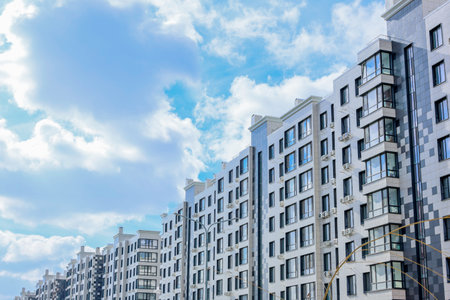 A modern contemporary apartment building beautifully framed by a stunningly picturesque sky above itの写真素材