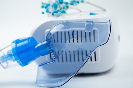 A close-up side view of a blue mask leaning against the machine on a white background and with blue...