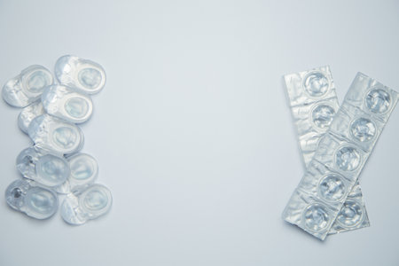 Daily disposable contact lenses in a disposable protective case lie in rows on the sides in...