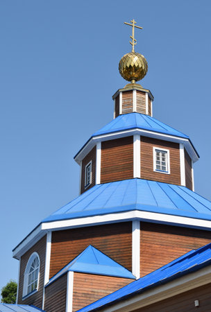 The old orthodox wooden Church on the background of blue skyの写真素材