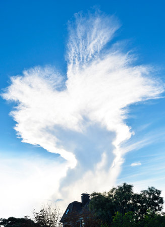 Beautiful view of a white, large cloud against a blue sunset skyの写真素材