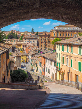 Perugia / Italy - June 2018: Medieval town in Italy, photographed from under the arch, juicy bright colors of Italian streetsのeditorial素材