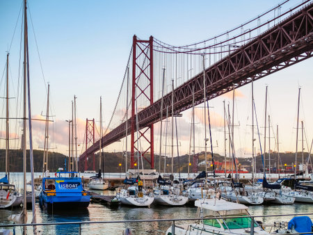 Red bridge in sunset with boats and yachtsのeditorial素材