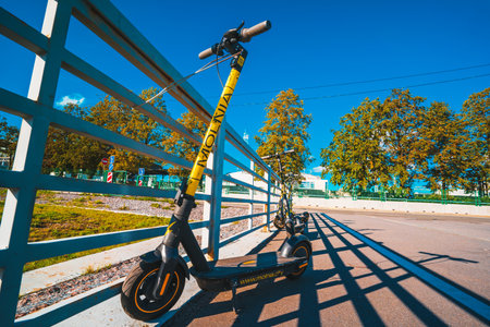 Electric scooters parked on street, scooters for rent for public useのeditorial素材