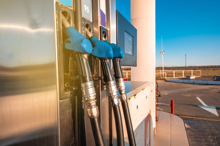 The hand holding the gun gas station refueling the carの写真素材
