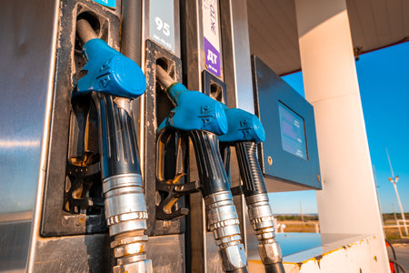 Blue fuel nozzle in Gas station. Fuel dispensing pump.