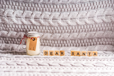 Christmas decorations with letters are on a gray knitted blanket, photo above. The concept of a cozy home new year on a knitted blanketの写真素材