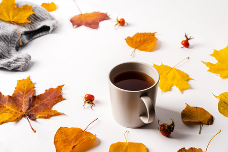 Autumn composition. Frame made of autumn yellow and red leaves with cup of tea. Top view, copy space.の写真素材