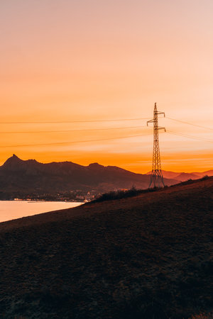 Amazing orange sunset on the sea with a view of mountains and hills, Crimea, Cape Chameleon. Sunset...