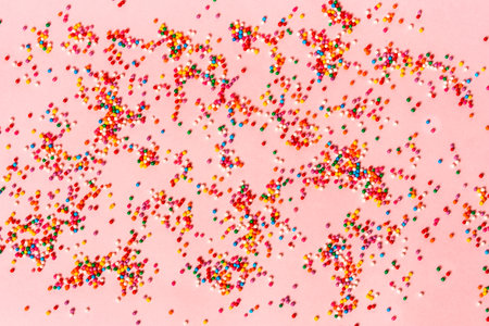 estive mood, colored pastry sprinkles on a pink backgroundの写真素材