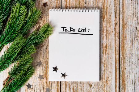 December calendar and notepad with to do list on a wooden background top view. The concept of planning Christmasの写真素材