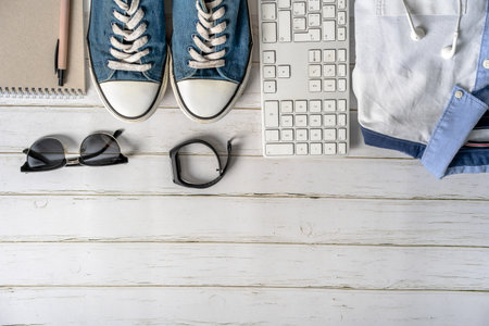 Men's casual outfits on wood board background, essential leisure items for the programmer: keyboard,...