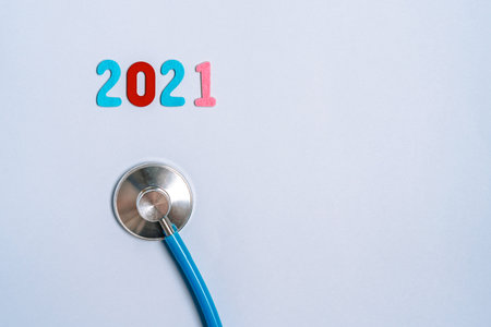 Stethoscope with the numbers 2021 on a blue background. Christmas for the health and medical banner...