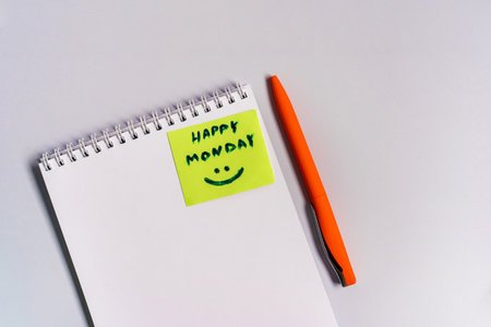 Office supplies on the table and clean notebooks, photo above. Motivational and inspirational quotes on your desktop keyboard - "Happy Monday"の写真素材