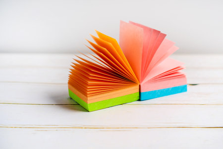 Note pad of sticky notes open like an fan, office stationery. Copy spaceの写真素材