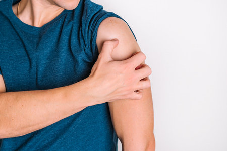 Young man scratches his hand. The concept of diseases and itching.