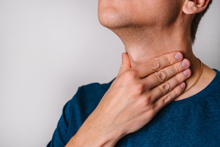 A man checks the lymph nodes on his neck.