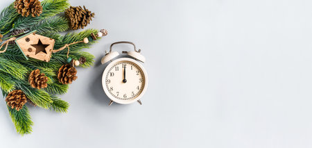 Christmas composition with an alarm clock and beautiful decorations on a blue backgroundの写真素材