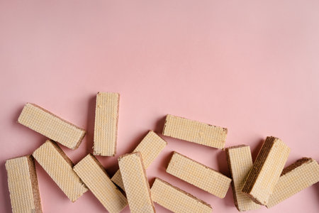 Waffle pattern on a pink background, waffles are in a rowの写真素材