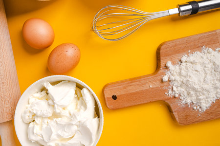 Ingredients and baking tools on a yellow background, top view. Cooking concept banner with copy space for textの写真素材