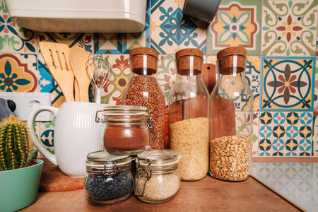 Modern stylish kitchen, glass jars with cereals and accessories on the shelfの写真素材