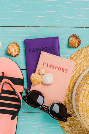 Vacation background, travel summer trip concept. Passports, sunglasses, seashells and camera on a wooden table, space for textの写真素材