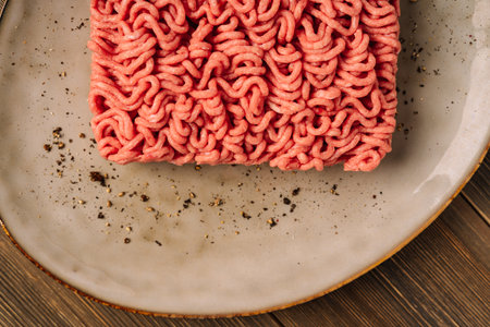 Fresh ground beef pork on a plate with seasonings