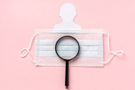 Medical mask and paper man. Concept of protection against coronavirus infection and other diseases