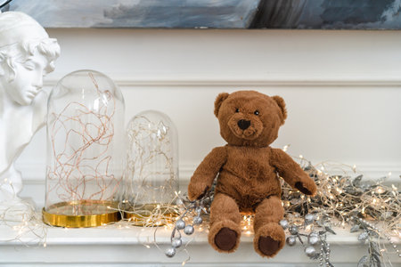 A toy bear sits on the scenery in the Christmas interiorの写真素材