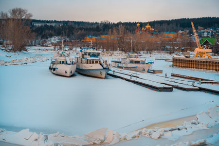 Yachts and boats are stored in winter. Frozen river