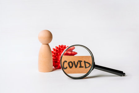 The wooden man and the syringe, a coronavirus vaccination conceptの写真素材