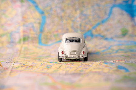Toy white car for traveling with a blank piece of paper for text on the map