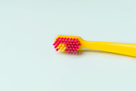 Yellow creative toothbrush on blue backgroundの写真素材