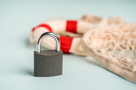 A locked padlock, and a lifebuoy as the concept of security and assistanceの写真素材