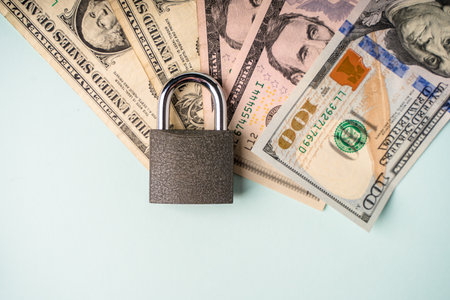 Locked lock on banknotes as a concept of financial security of deposits and money storageの写真素材
