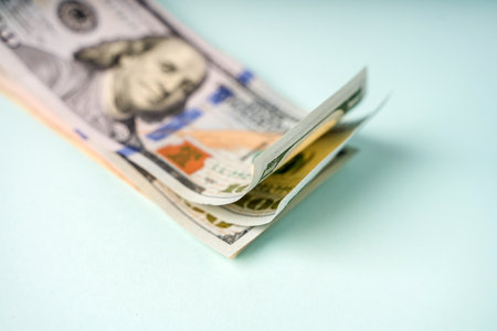 Paper money dollars lie on a blue background, selective focus and space for text