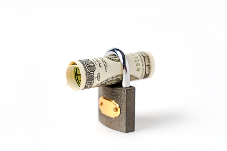 Locked lock on banknotes as a concept of financial security of deposits and money storageの写真素材