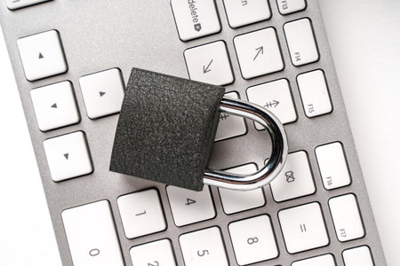 Concept of a computer security. Locked padlock on a white laptop keyboard.の写真素材