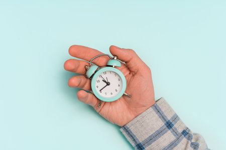 Hands hold the alarm clock. The concept of spending time usefully, business managementの写真素材