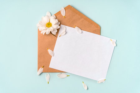Spring top view of the composition: the envelope and the petals of daisies. Pastel background with copy space for text.の写真素材