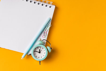 Blank notepad for copy space in office style on a yellow background with paper clips, stickersの写真素材