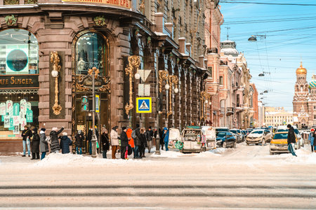 A busy street in the center of St. Petersburg on a sunny winter day, a view of the Singer(Zinger) house. St Petersburg, Russia - 25 Feb 2021のeditorial素材