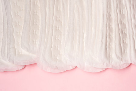 Women's hygiene daily pads on pink background