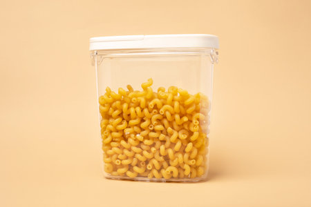 Different types of pasta in containers on a beige background